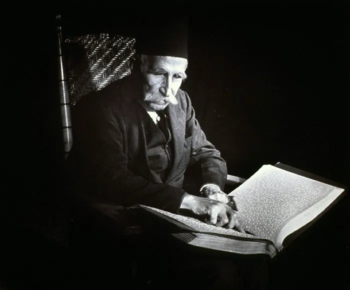 Framed Print : Blind man reading a Braille book, ca. 1938