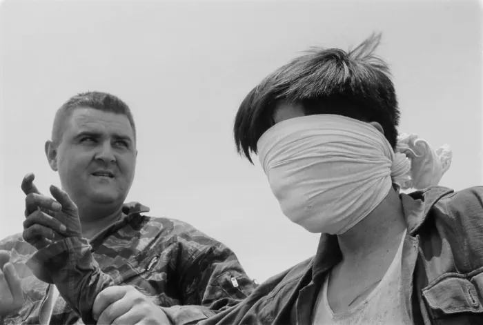 Framed Print : Blindfolded Viet Cong POW. US Marine Sergeant guides a blindfolded POW in Quang Tri Province, during the first significant action between US and Viet Cong Forces