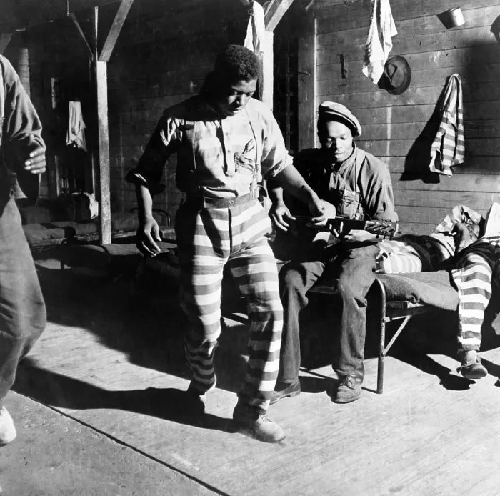 Framed Print : The Blues. A Negro convict dances while another plays the guitar at a prison camp. Greene County, Georgia. Photo by Jack Delano, 1941