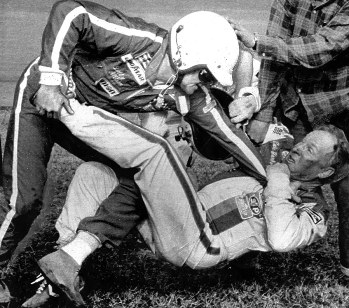 Framed Print : Bobby Allison (L)fights with Cale Yarborough (R) after a collision between Allison and Yarborough on the final lap of the race cost Allison the victory