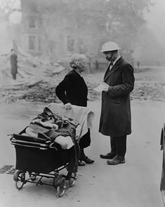 Framed Print : A bombed out London women carrying a few belongings talks with an Air Raids Precautions worker. 1940 during the Battle of Britain in World War 2. (BSLOC_2013_14_17) Framed Print : A bombed out London women carrying a few belongings talks with an Air Raids Precautions worker. 1940 during the Battle of Britain in World War 2. (BSLOC_2013_14_17)