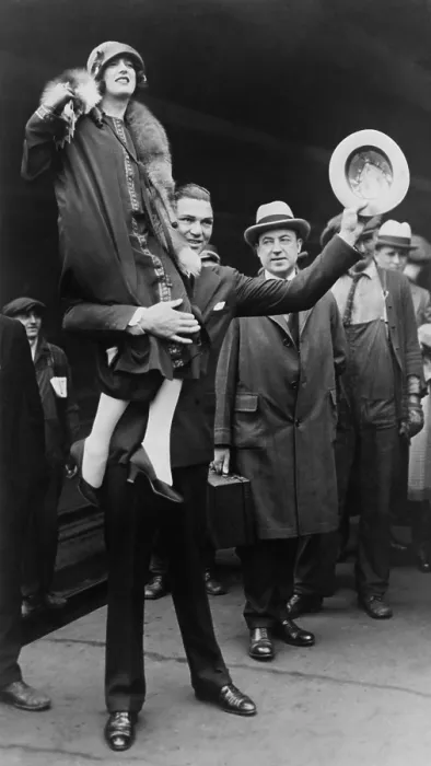 Framed Print : Boxer Jack Dempsey in Chicago, hoisting his bride, Estelle Taylor, on his right shoulder. April 22, 1925. The movie actress was his second wife. (BSLOC_2015_17_74)