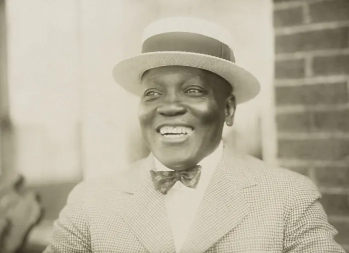 Framed Print : Boxer John Johnson, smiling broadly, in a checkered jacket, bow tie, and straw hat, c. 1909-12. He held the World Heavyweight Championship from Dec Framed Print : Boxer John Johnson, smiling broadly, in a checkered jacket, bow tie, and straw hat, c. 1909-12. He held the World Heavyweight Championship from Dec