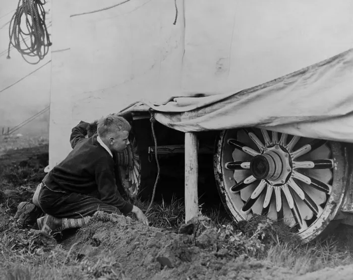 Framed Print : Boy looking under a circus tent to catches a glimpse of the show, ca. 1935. (BSLOC_2013_8_105)