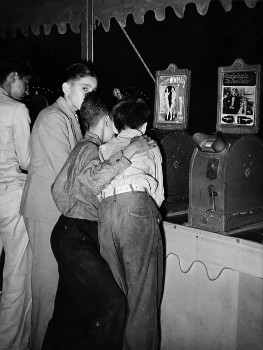 Framed Print : Boys looking at penny movies at South Louisiana State Fair, viewing WIGGLING WONDERS, next to a machine showing Charlie Chaplin in THE DUMB WAITER, photograph by Lee Russell Framed Print : Boys looking at penny movies at South Louisiana State Fair, viewing WIGGLING WONDERS, next to a machine showing Charlie Chaplin in THE DUMB WAITER, photograph by Lee Russell