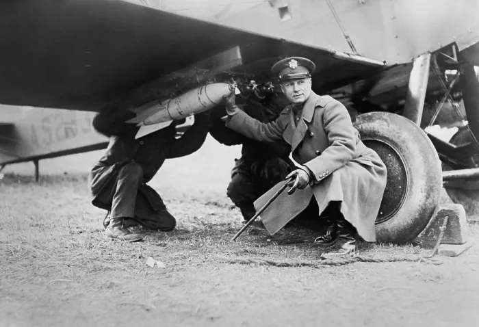 Framed Print : Brigadier General Billy Mitchell and another man, attaching a bomb under wing of airplane. Ca. 1925 Framed Print : Brigadier General Billy Mitchell and another man, attaching a bomb under wing of airplane. Ca. 1925
