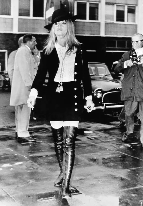 Framed Print : Brigitte Bardot in a miniskirt, and thigh high boots and a Bonnie and Clyde style wide brimmed hat. She was arriving in London to work on her latest film. April 22, 1968 Framed Print : Brigitte Bardot in a miniskirt, and thigh high boots and a Bonnie and Clyde style wide brimmed hat. She was arriving in London to work on her latest film. April 22, 1968