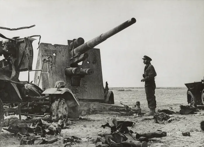 Framed Print : British army officer looks at a destroyed German dual purpose 88 millimeter gun. It was put out of action by British Artillery near El Gubbi. Ca. 1940-42 during World War 2 Framed Print : British army officer looks at a destroyed German dual purpose 88 millimeter gun. It was put out of action by British Artillery near El Gubbi. Ca. 1940-42 during World War 2