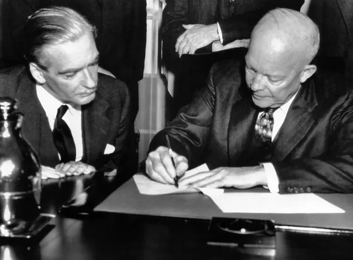 Framed Print : British Prime Minister Anthony Eden watches as President Dwight D. Eisenhower signs a joint statement on the 3 day talks between the two. February 1, 1956 Framed Print : British Prime Minister Anthony Eden watches as President Dwight D. Eisenhower signs a joint statement on the 3 day talks between the two. February 1, 1956