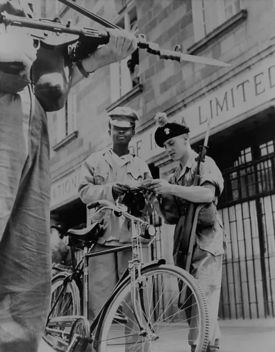 Framed Print : British soldiers examining papers of an African cyclist at gunpoint, in Nairobi, Kenya, 1953 Framed Print : British soldiers examining papers of an African cyclist at gunpoint, in Nairobi, Kenya, 1953