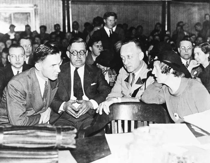 Framed Print : Bruno Hauptmann shown leaning over for a whispered word with his wife, Anna Hauptmann. Deputy Hovey Low and a state trooper are shown between them. Ca. Jan. 24, 1935