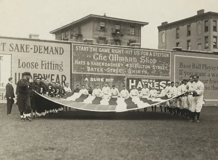 Framed Print : Buffalo Bisons and Brooklyn Tip Tops baseball players holding a large American flag, 1914