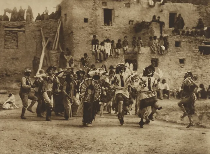 Framed Print : BUFFALO DANCE AT HANO, 1921, by Edward S. Curtis. Spectators positioned on the rooftops view of ceremonial dance in the pueblo courtyard