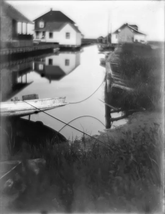 Framed Print : Bungalows at the water's edge in Oceanside, a small passageway of water flanked by houses and docks, Long Island, New York, photograph by Gertrude Kasebier, 1905