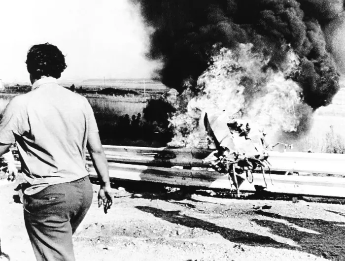 Framed Print : Burning wreckage of Peter Revson's race car jammed against the race track guard rail. The fatal crash occurred during a practice session for the South African Grand Prix Framed Print : Burning wreckage of Peter Revson's race car jammed against the race track guard rail. The fatal crash occurred during a practice session for the South African Grand Prix