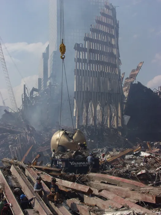 Framed Print : Cables are placed around THE SPHERE sculpture by German sculptor Fritz Koenig before it is hoisted out of the rubble, September 21, 2001. Photo: Everett Collection