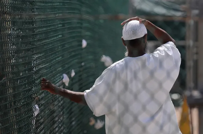 Framed Print : In Camp Delta prison at Guantanamo Bay Naval Base Cuba a detainee stands in the recreation yard. June 8 2010. Photo by:Everett Collection(BSLOC_2011_6_143)