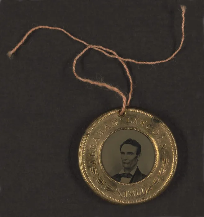 Framed Print : Campaign button for 1860 presidential election showing bust tintype portrait of Abraham Lincoln in a metal casing