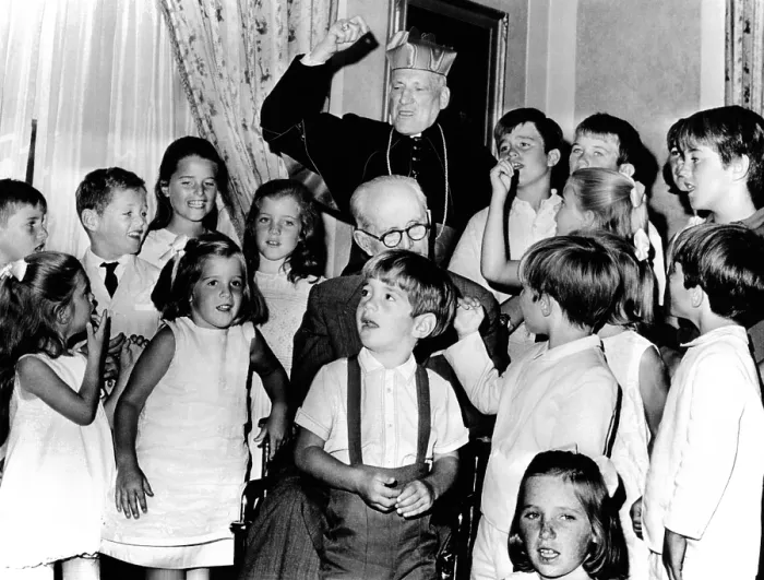 Framed Print : Cardinal Richard Cushing leads the Kennedy children in singing Happy Birthday'. They were celebrating their grandfather's 70th birthday. Former Ambassador Joseph P