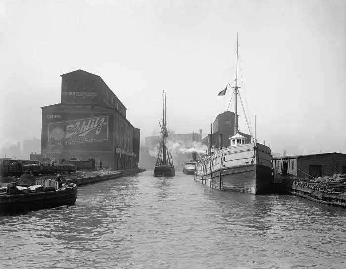 Framed Print : Cargo ships in the Chicago River. Warehouses and grain elevators line the urban river banks of the Port of Chicago. 1900. LC-D4-12626