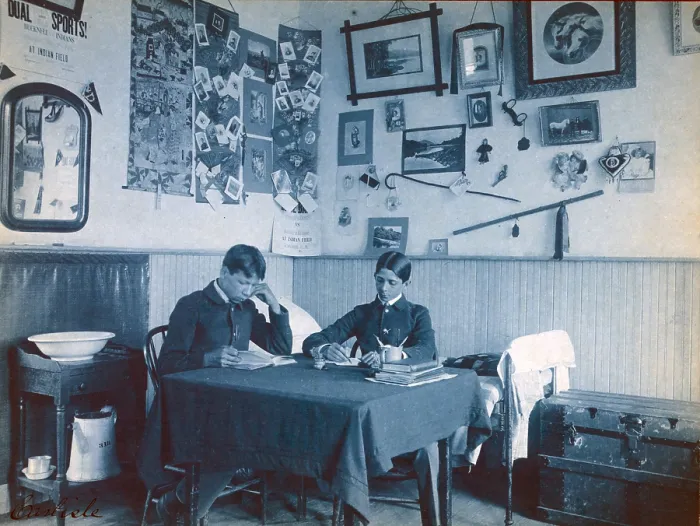 Framed Print : Carlisle Indian School, Carlisle, Pa. Two Native Americans boys studying in dormitory room. Cyanotype by Frances Benjamin Johnston ca. 1901
