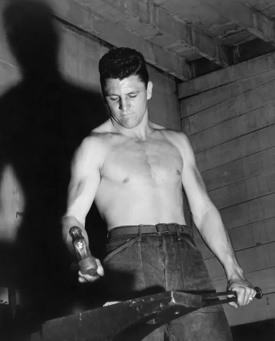 Framed Print : CCC enrollee forging a piece of steel in a CCC blacksmith shop. 1930s. (BSLOC_2013_8_21)