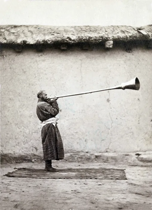 Framed Print : Central Asian man playing a long necked Uzbek instrument called a karnay. 1868