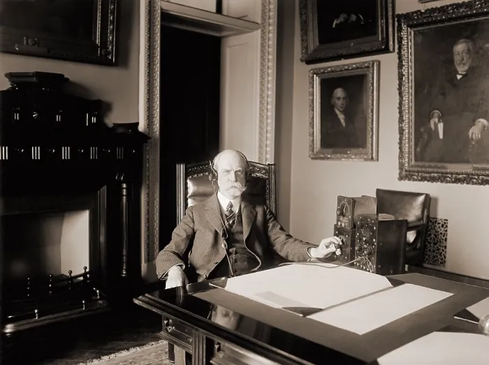 Framed Print : Charles Evans Hughes (1862-1948), Secretary of State during the Harding administration, listening to an early radio in his office. 1922