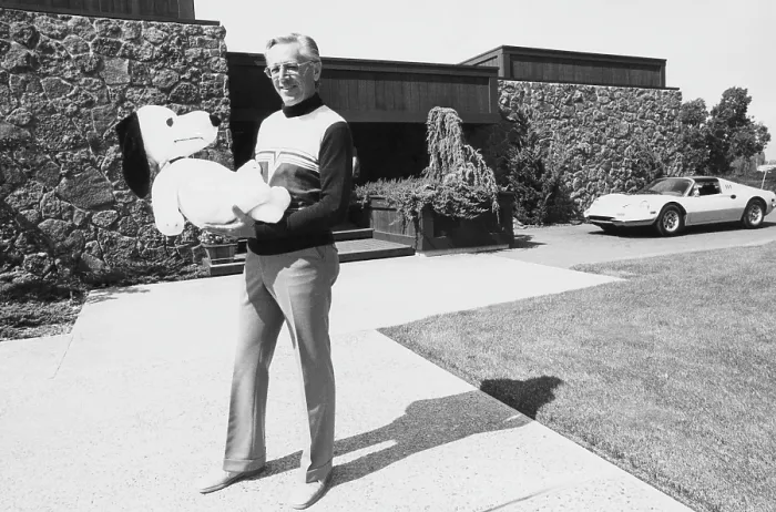 Framed Print : Charles M. Schulz, (1922-2000), American cartoonist and creator of the comic strip Peanuts, holding a Snoopy doll, Santa Rosa, California, 1975