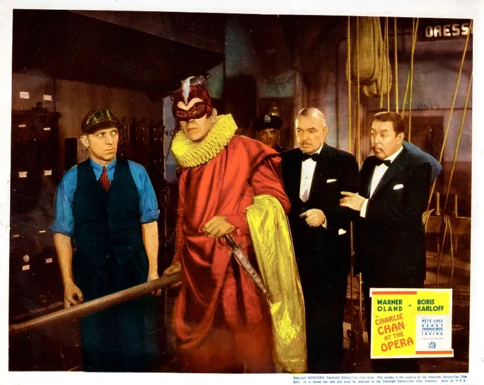 Framed Print : CHARLIE CHAN AT THE OPERA, lobbycard, Boris Karloff (red), Fred Kelsey (back, center), Frank Conroy (right of center), Warner Oland (right), 1936