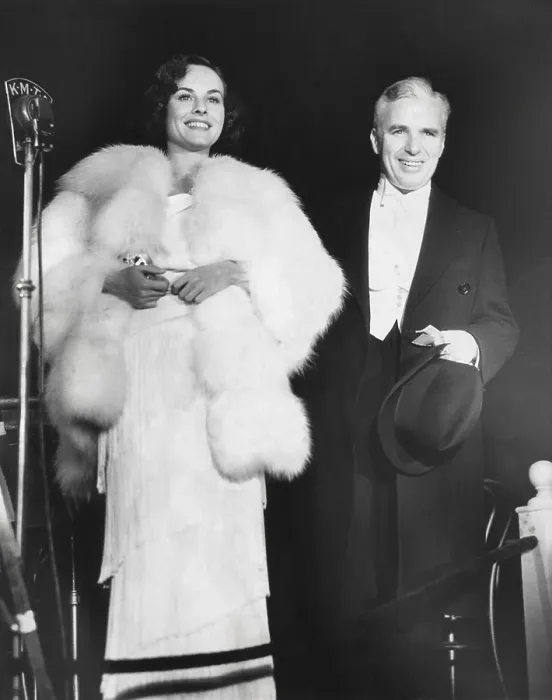 Framed Print : Charlie Chaplin attends the premiere of MODERN TIMES with his leading lady, Paulette Goddard. The film had no dialogue but employed sound effects and was a big success