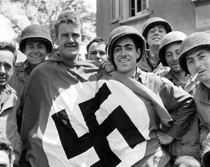 Framed Print : CHERBOURG, FRANCE-- A comandeered Nazi flag held by American soldiers after the liberation of Cherbourg, July 1, 1944. Courtesy: CSU Archives  /  Everett Collection