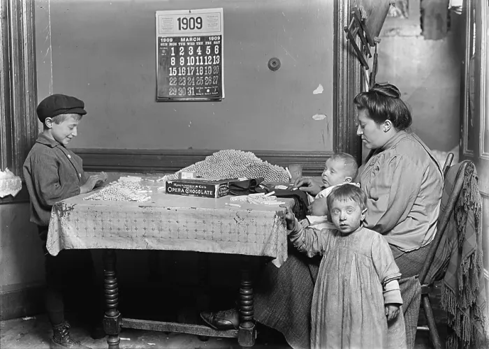 Framed Print : Child labor, Widow & boy rolling papers for cigarettes in a dirty tenement, New York, photograph by Lewis Wickes Hine, March, 1909