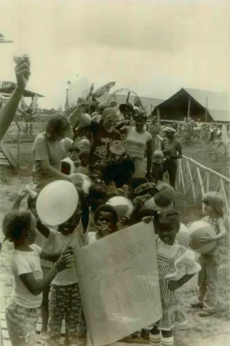 Framed Print : Children from the Jonestown Pre-School in a parade carrying a poster. People's Temple Agricultural Project. Jonestown, Guyana. Nov. 1978
