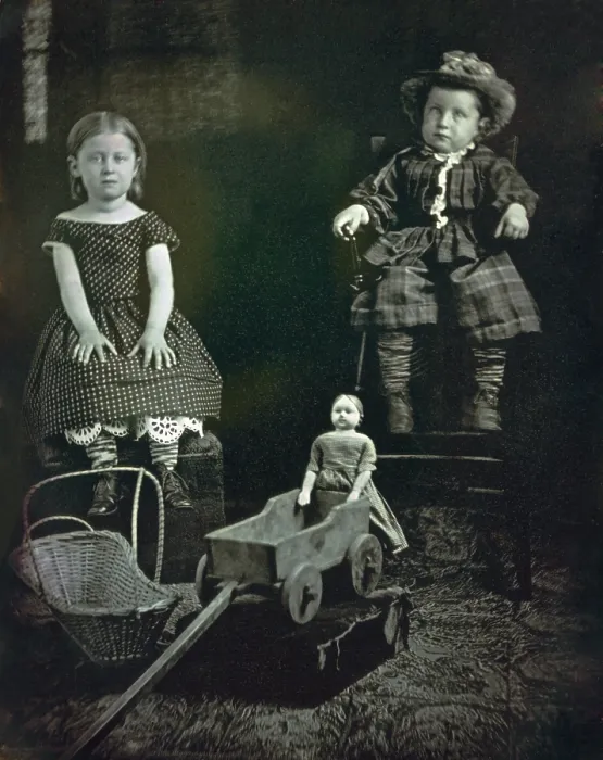 Framed Print : Two Children with Toys, ca. 1855, by an unidentified photographer. A girl and boy pose with their handcrafted toys: a doll, wagon and basket cradle (BSLOC_2019_8_161)