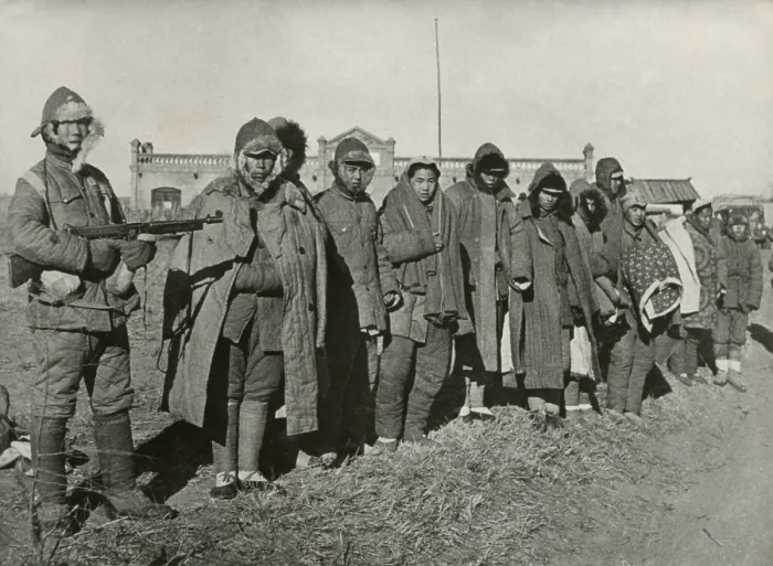 Framed Print : Chinese Civil War 1946-1949. Troops of the 38E Division of Nationalists Chinese Army in Manchuria guard Communist prisoners. Jan. 9, 1947. - (BSLOC_2014_15_167)