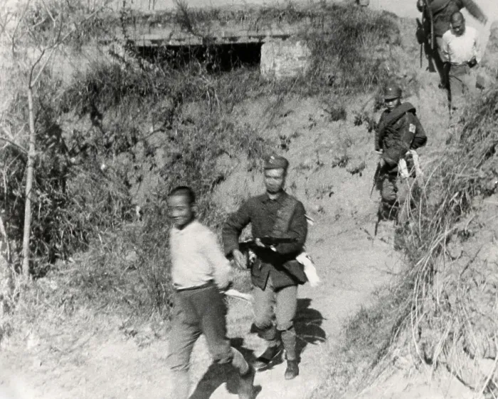 Framed Print : Chinese Communist soldiers are taken from a tower captured by government forces. The fighting took place along the border of Kiangsi and Fukien provinces in January 1934