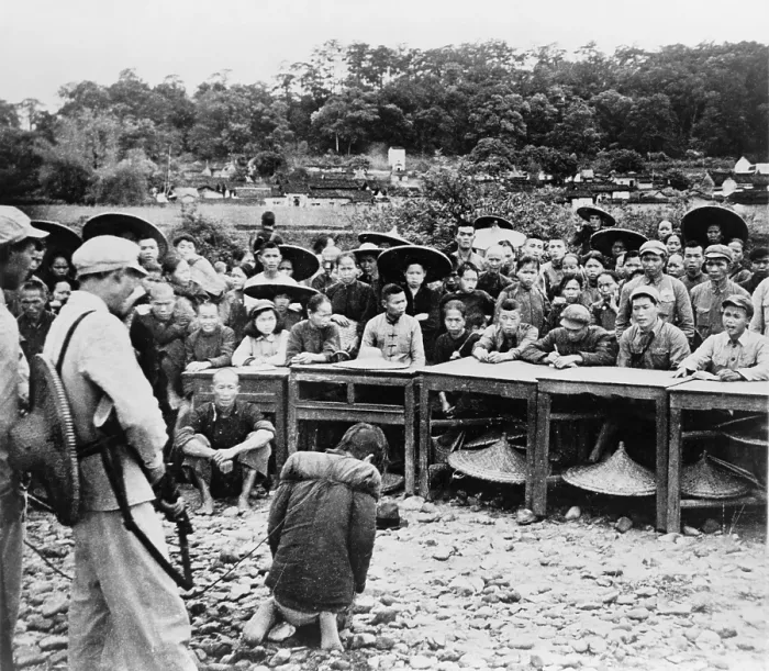 Framed Print : Chinese farmer, kneeling at gunpoint before a court enforcing communist land reforms in July 1952