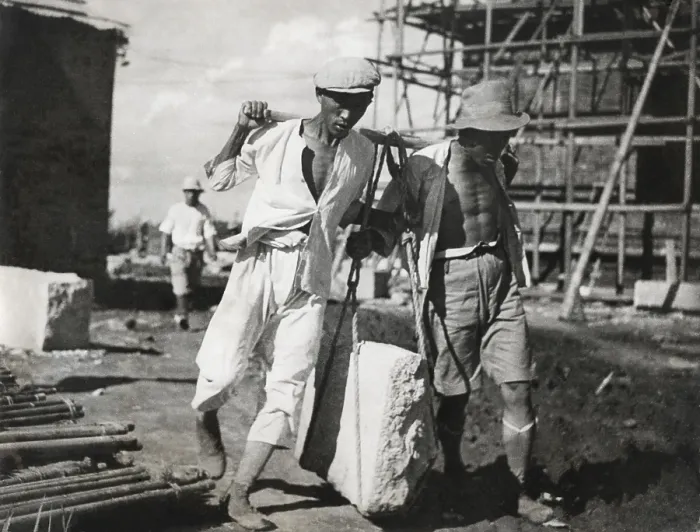 Framed Print : Two Chinese men work together to life a large stone on a construction site. They use traditional, pre-industrial lifting techniques. Ca. 1930-40s. - (BSLOC_2014_15_151) Framed Print : Two Chinese men work together to life a large stone on a construction site. They use traditional, pre-industrial lifting techniques. Ca. 1930-40s. - (BSLOC_2014_15_151)