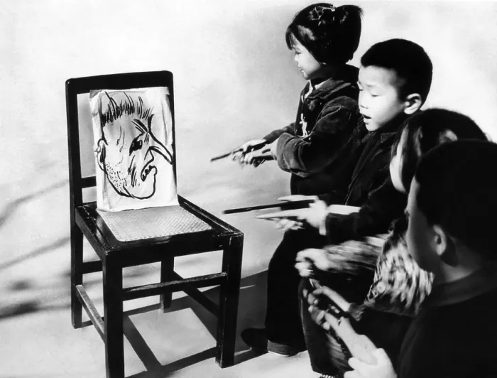 Framed Print : Chinese youngsters aim toy pistols at the big nosed caricature of President Lyndon Johnson. Anti-American activities are part of elementary school lessons in Changchow, China