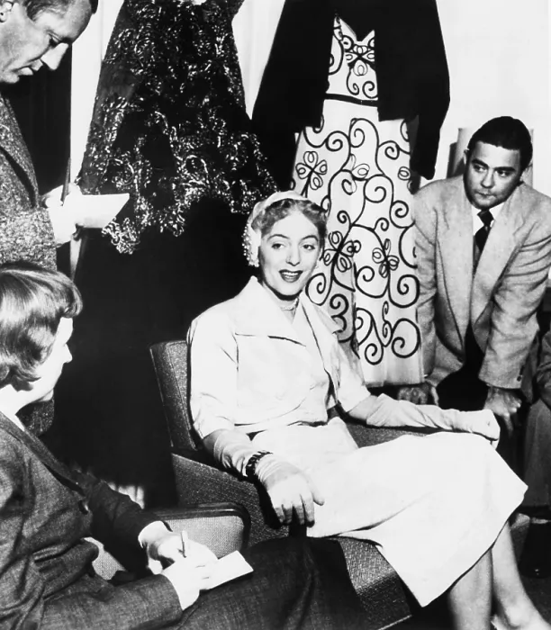 Framed Print : Christine Jorgensen, displays her night club act wardrobe at a press conference. She expressed discomfort at being turned into a joke, and being considered a freak Framed Print : Christine Jorgensen, displays her night club act wardrobe at a press conference. She expressed discomfort at being turned into a joke, and being considered a freak