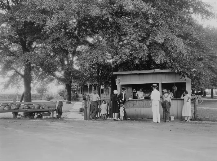 Framed Print : City folk in their high heels, cloche hat, suit, and neat toddler clothes at roadside food stand. 1925-30