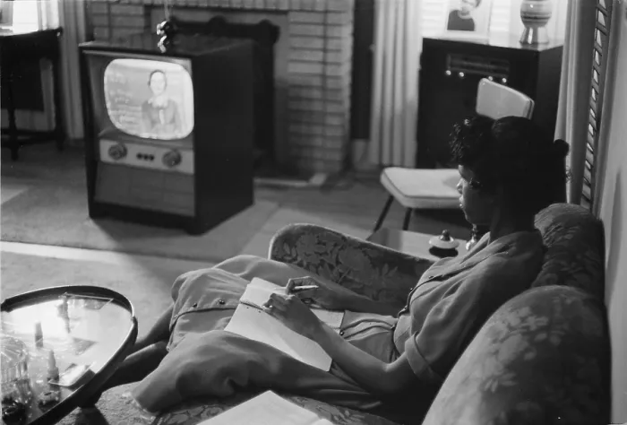 Framed Print : Civil Rights, an African American high school girl being educated via television during the period that schools were closed to avoid integration, photograph by Thomas J