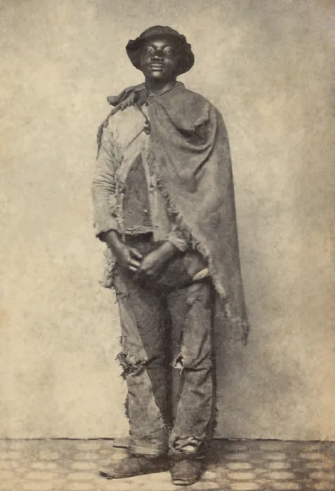 Framed Print : Civil War African American contraband wearing cleverly mended trousers, and a frayed blanket cape, c