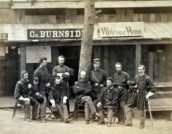 Framed Print : Civil War. Ambrose Everett Burnside with eight officers of the lst Rhode Island Volunteers in front of building, with sign reading 'Col