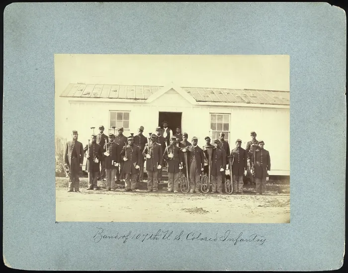Framed Print : The Civil War, group of 21 African American men holding musical instruments, title: Band of 107th U.S. Colored Infantry, Arlington, Virginia, photograph by William M Framed Print : The Civil War, group of 21 African American men holding musical instruments, title: Band of 107th U.S. Colored Infantry, Arlington, Virginia, photograph by William M