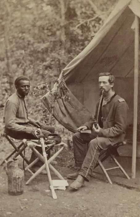 Framed Print : Civil War Union officer of 23d New York Infantry smoking a long stem pipe outside his tent, 1861-1863. An African American in civilian clothes sits nearby