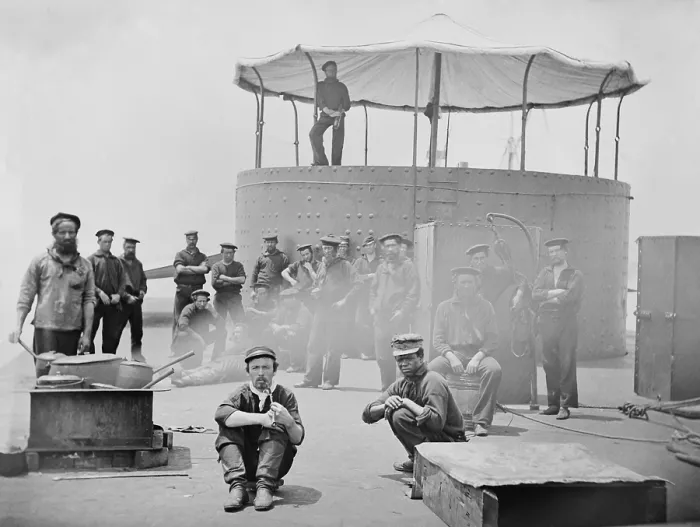 Framed Print : US Civil War. The USS Monitor, the Union ironclad gunboat after the Battle of Hampton Roads. Sailors gather on the deck of USS Monitor as a cook oversees pots on a stove