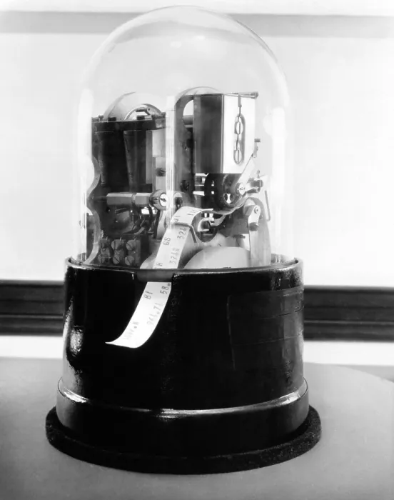 Framed Print : Classic 1920's stock ticker with a glass dome. Stock tickers were specialized telegraphs that conveying stock prices. Ca. 1915-1930 Framed Print : Classic 1920's stock ticker with a glass dome. Stock tickers were specialized telegraphs that conveying stock prices. Ca. 1915-1930