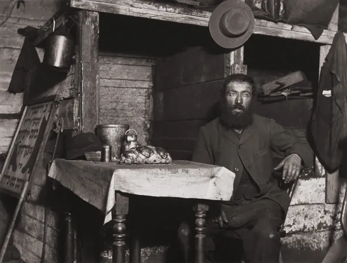 Framed Print : A cobbler in Ludlow Street sits down for Sabbath Eve in his coal celler lodging, c. 1889-90. Photo by Jacob Riis (BSLOC_2018_1_79) Framed Print : A cobbler in Ludlow Street sits down for Sabbath Eve in his coal celler lodging, c. 1889-90. Photo by Jacob Riis (BSLOC_2018_1_79)